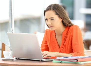 woman sitting at desk working on laptop